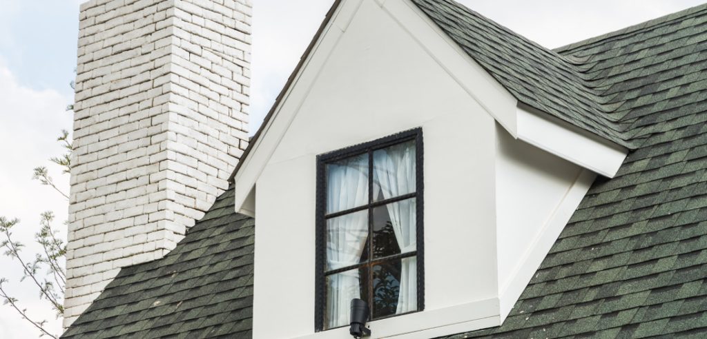 House Dormer Window With Green Shingle Roof And Chimney
