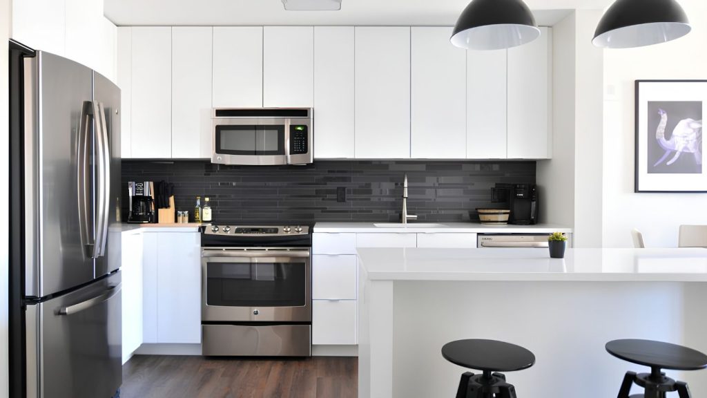 White Kitchen With Stainless Appliances And Island